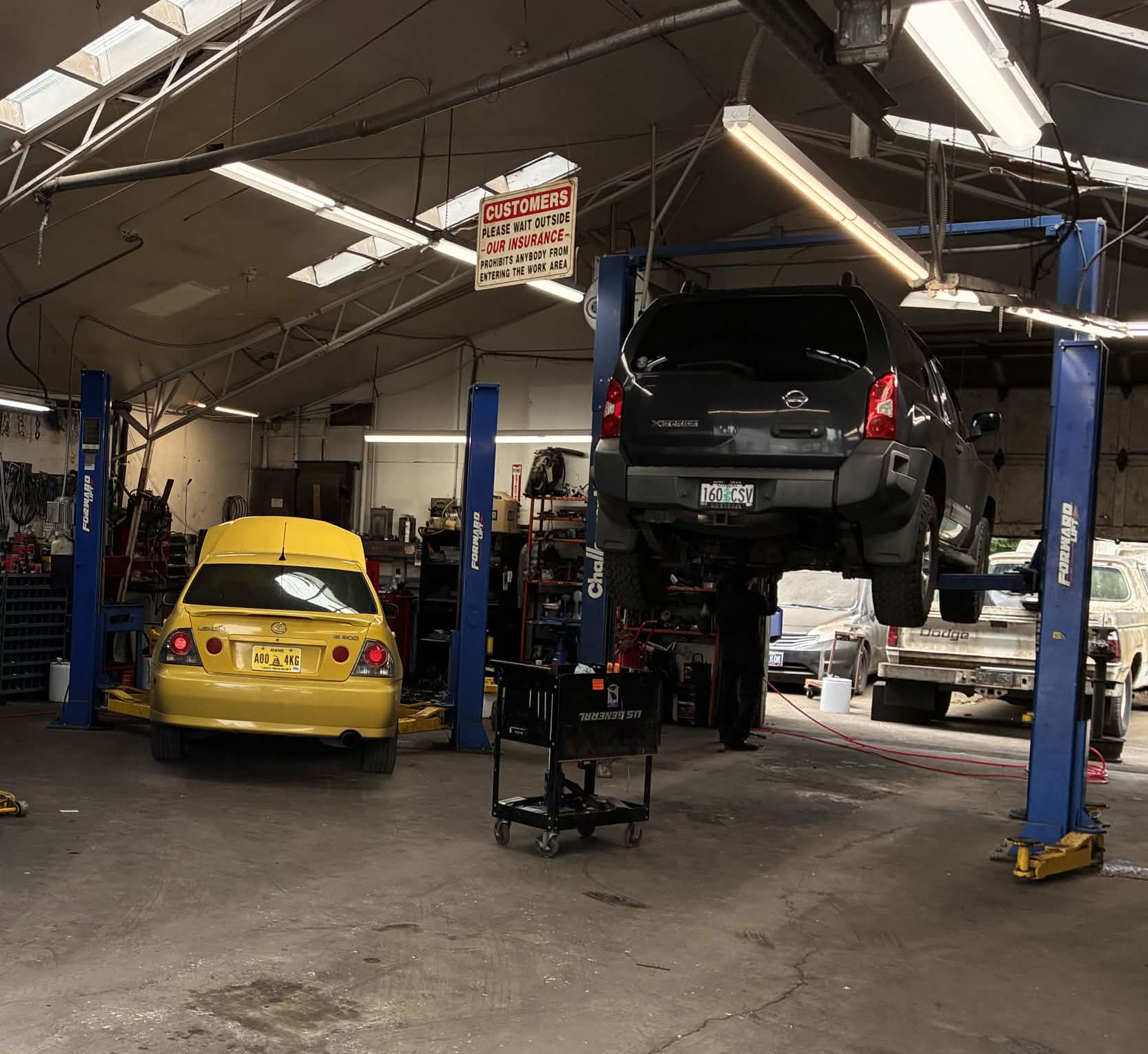 Technician working on an engine at Fix 4 Less Auto